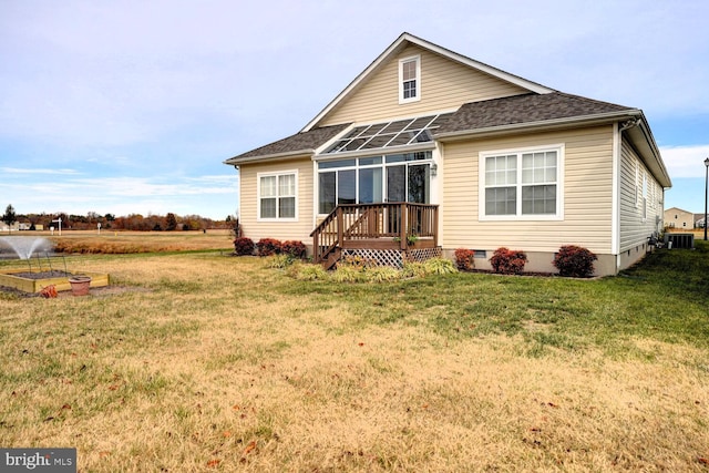 rear view of house featuring cooling unit, a yard, and a wooden deck