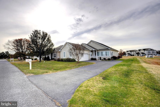 single story home with a front yard and a garage