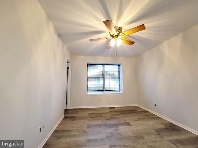 empty room with hardwood / wood-style floors and ceiling fan