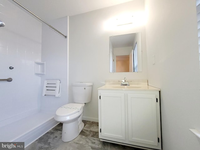 bathroom featuring a shower, vanity, and toilet