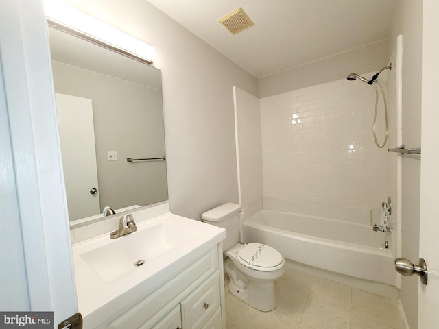 full bathroom with tile patterned floors, vanity, tiled shower / bath combo, and toilet