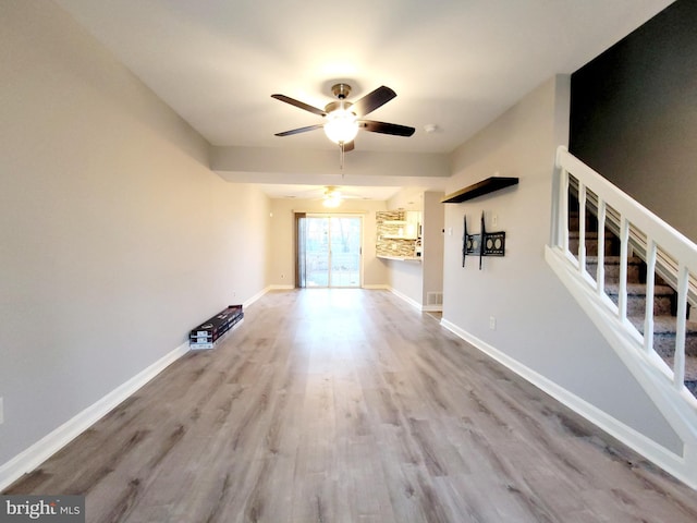 unfurnished living room with ceiling fan and light hardwood / wood-style flooring