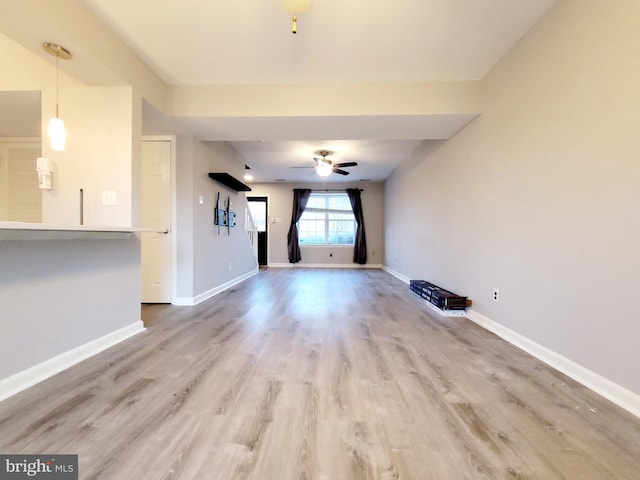 unfurnished living room with hardwood / wood-style floors and ceiling fan