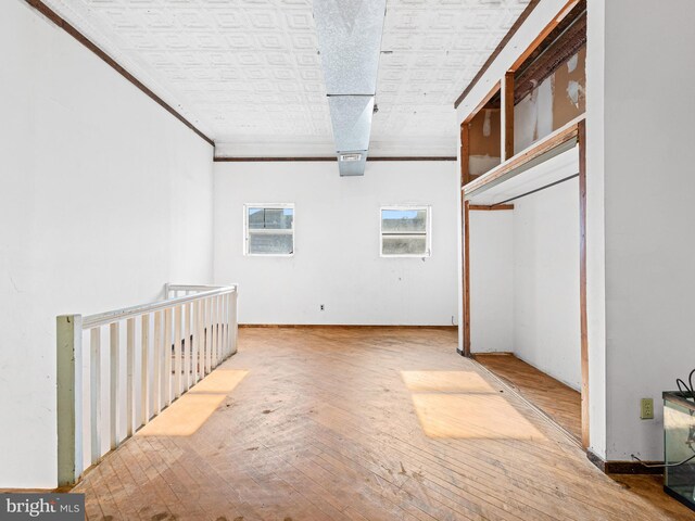 interior space featuring hardwood / wood-style floors and ornamental molding