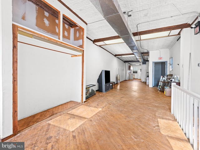 basement with light hardwood / wood-style flooring