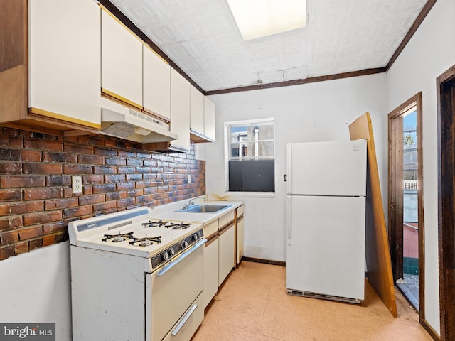 kitchen with white cabinets, plenty of natural light, white appliances, and sink