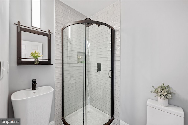 bathroom featuring an enclosed shower and toilet