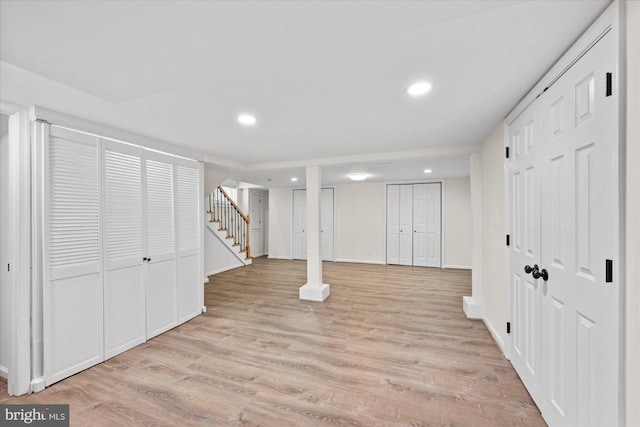 basement with light hardwood / wood-style floors