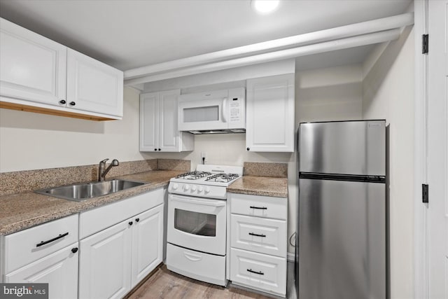 kitchen with light hardwood / wood-style floors, white cabinetry, white appliances, and sink