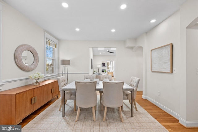 dining area featuring ceiling fan and light wood-type flooring