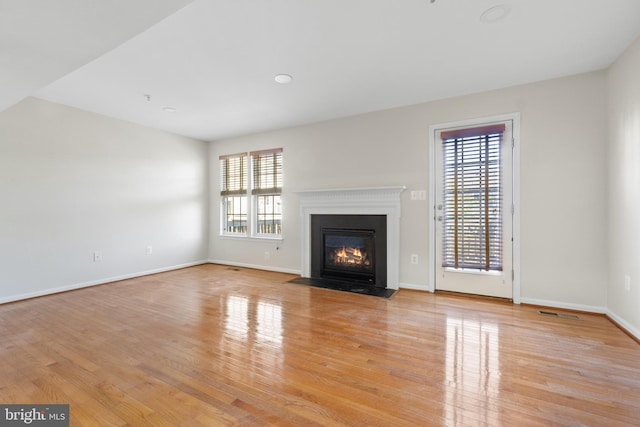 unfurnished living room with light hardwood / wood-style floors