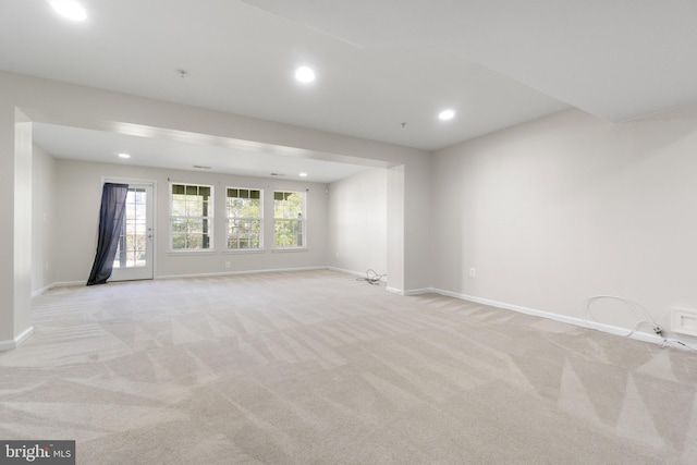 unfurnished room featuring light colored carpet