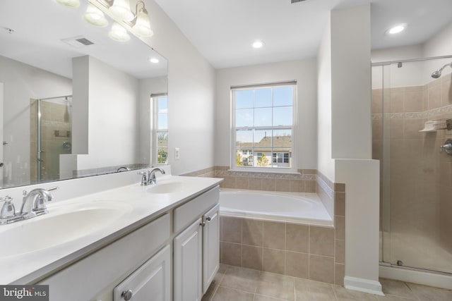 bathroom with vanity, tile patterned floors, and plus walk in shower