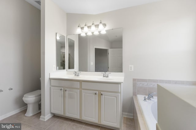 bathroom featuring vanity, tiled tub, tile patterned flooring, and toilet