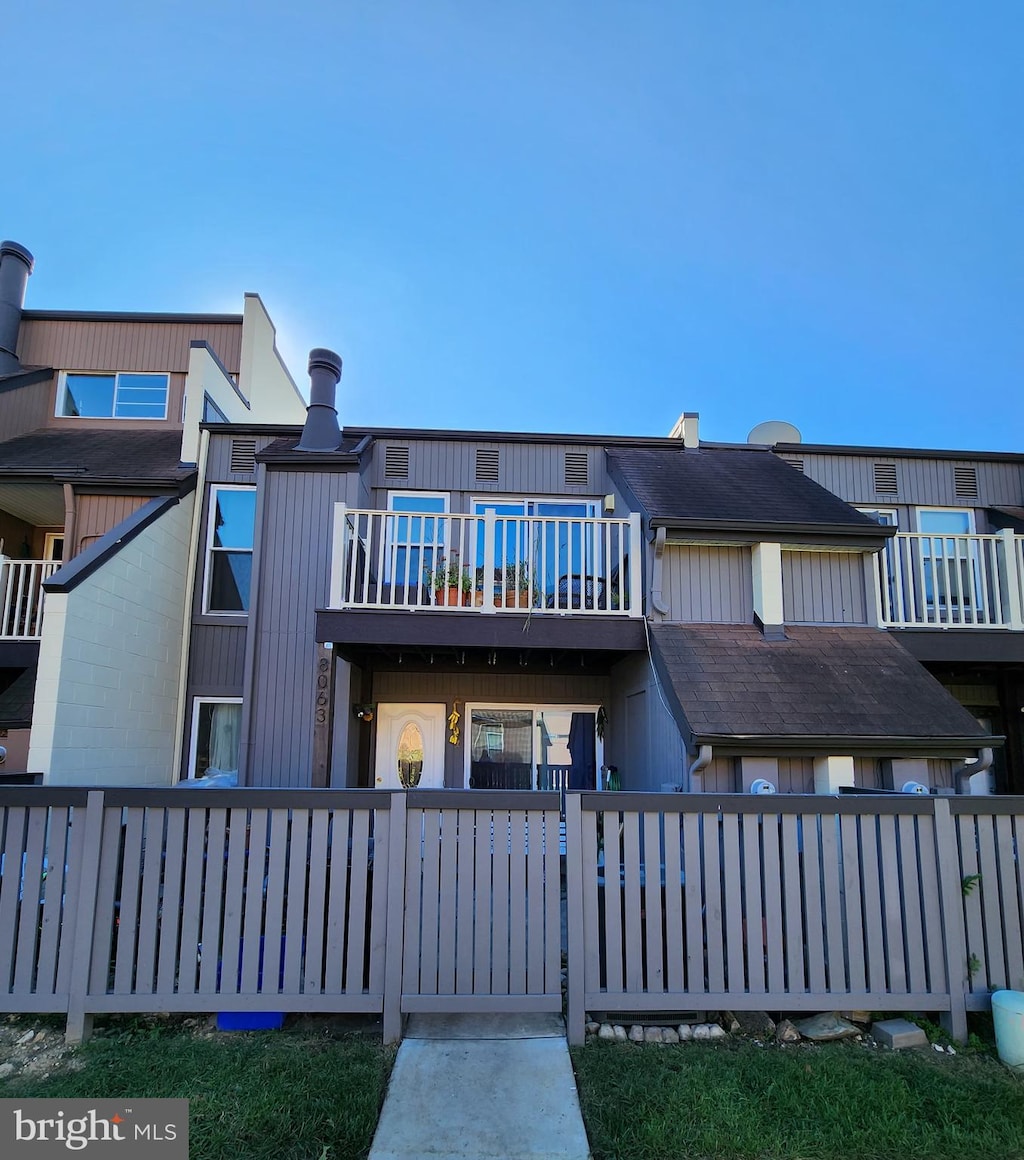 rear view of property featuring a balcony