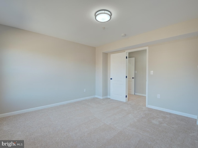 empty room with light colored carpet