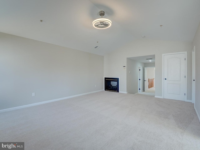 unfurnished living room featuring light colored carpet and lofted ceiling