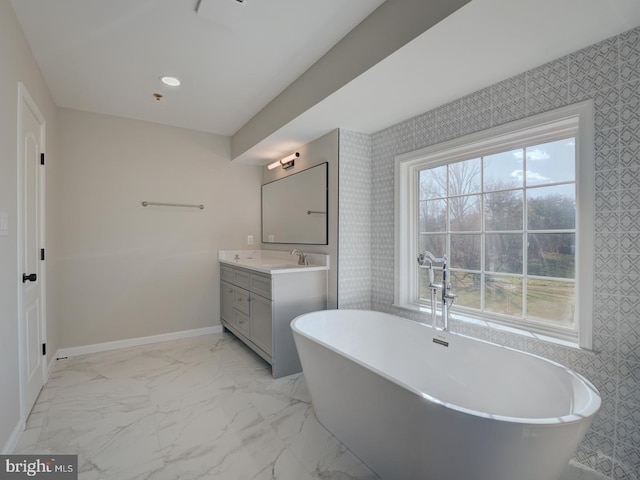 bathroom featuring vanity and a tub