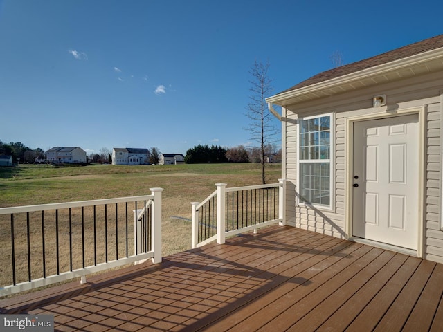 wooden deck featuring a yard