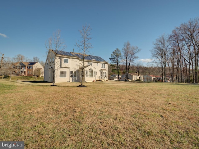 rear view of house with a lawn