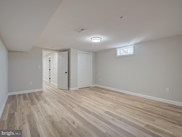 basement with light hardwood / wood-style floors