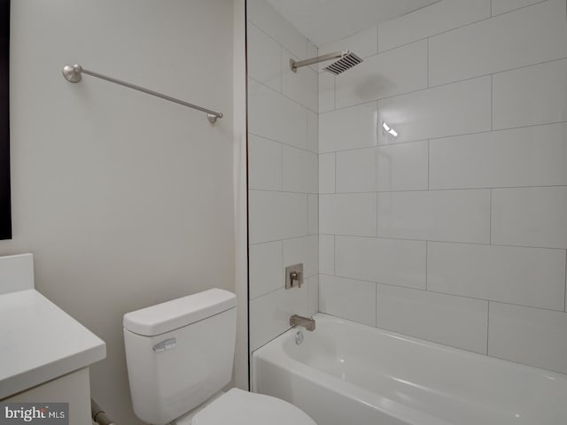 full bathroom featuring vanity, toilet, and tiled shower / bath