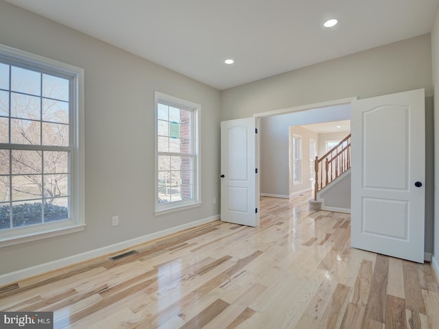 spare room with light hardwood / wood-style floors