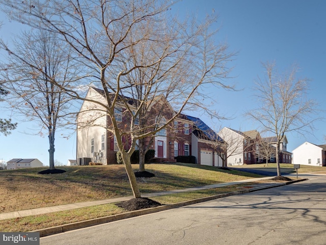 view of front of home with a garage and a front lawn