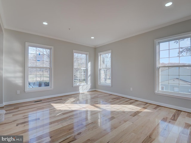 unfurnished room with crown molding and light hardwood / wood-style floors