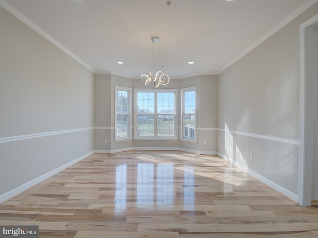 unfurnished dining area with light hardwood / wood-style floors, crown molding, and a notable chandelier