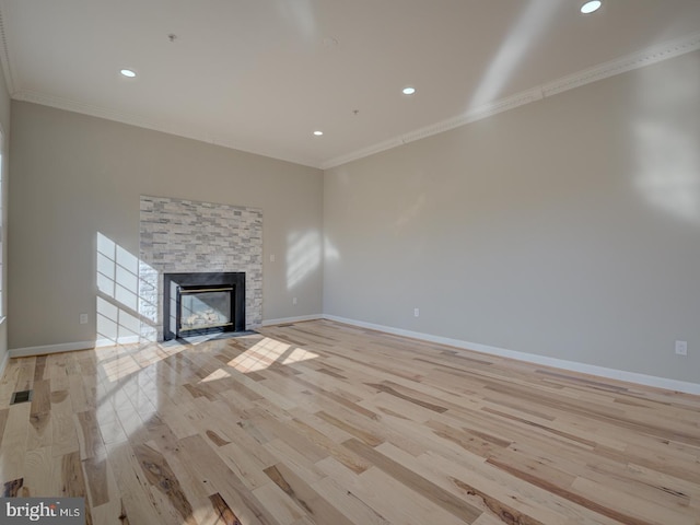 unfurnished living room with a fireplace, light hardwood / wood-style floors, and ornamental molding