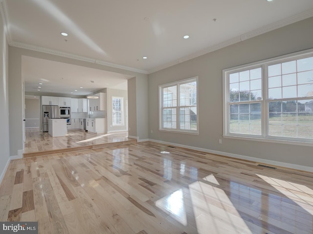 unfurnished living room featuring light hardwood / wood-style floors and ornamental molding