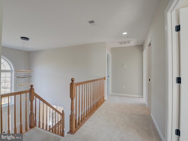 corridor featuring light colored carpet