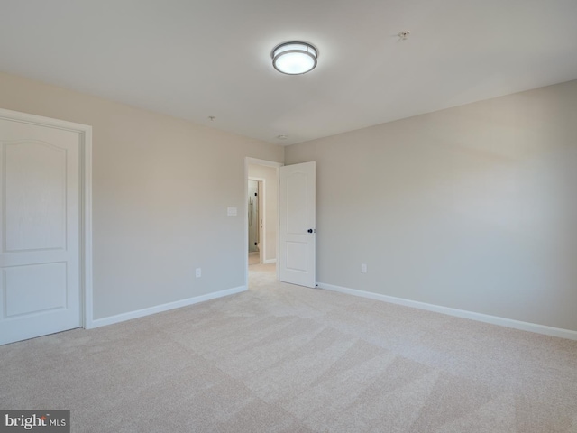 unfurnished room with light colored carpet