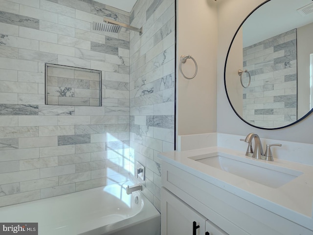 bathroom with vanity and tiled shower / bath combo