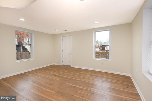 empty room with hardwood / wood-style flooring