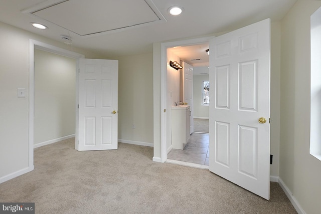 interior space featuring light colored carpet and sink