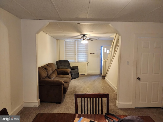 carpeted living room with ceiling fan