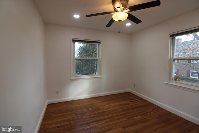 unfurnished room with ceiling fan and dark wood-type flooring