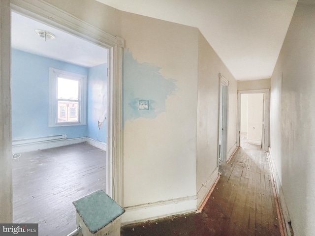 hall with dark hardwood / wood-style flooring and baseboard heating