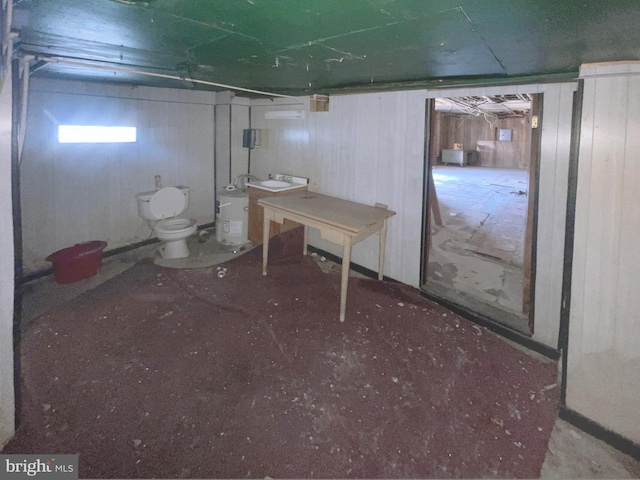 basement featuring washer / clothes dryer and wood walls