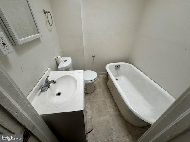 bathroom with tile patterned flooring, a bath, vanity, and toilet