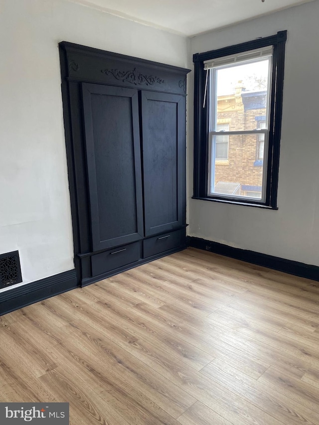 spare room featuring light wood-type flooring