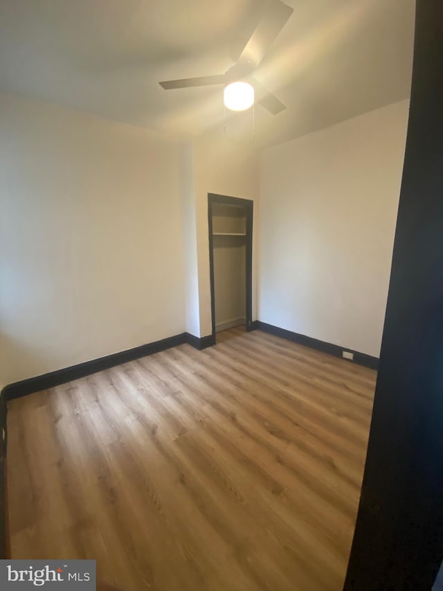 spare room featuring hardwood / wood-style flooring and ceiling fan