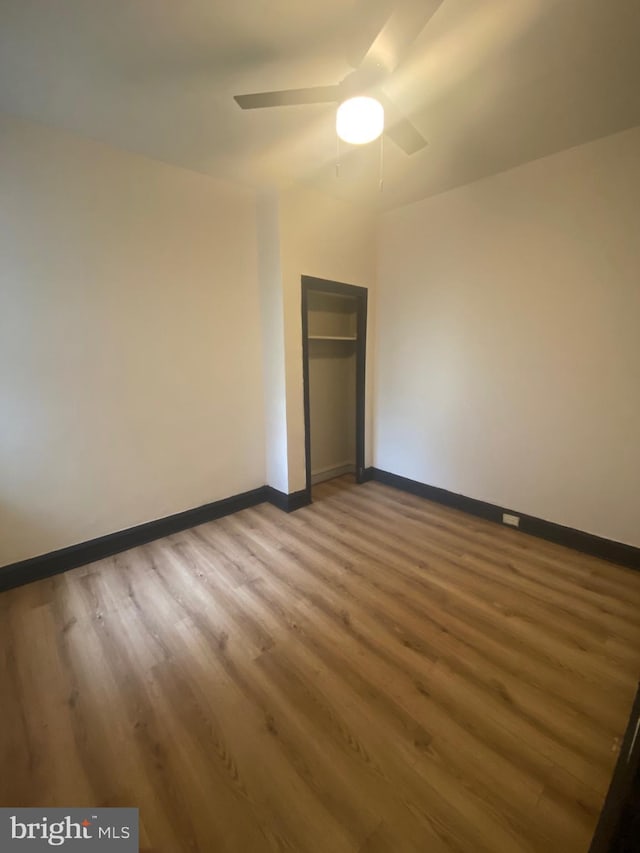 spare room featuring hardwood / wood-style flooring and ceiling fan