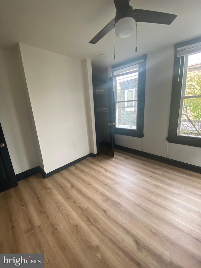 empty room featuring ceiling fan and light wood-type flooring