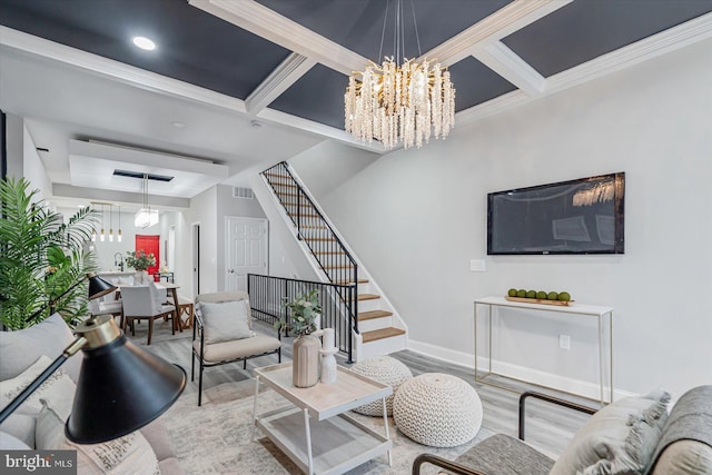 living room with light wood-type flooring, coffered ceiling, crown molding, beam ceiling, and an inviting chandelier