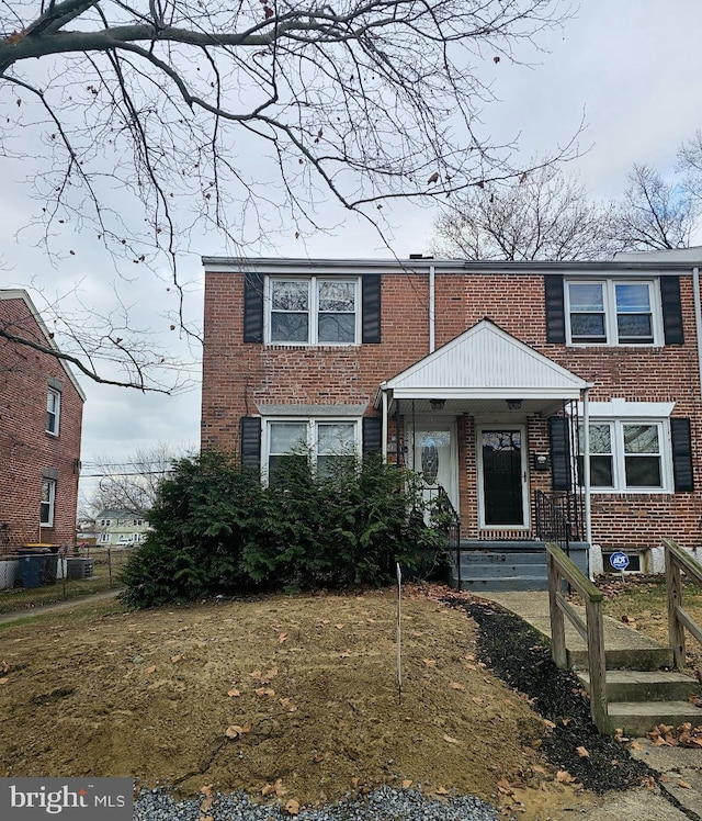 view of front facade with a front yard and central AC unit