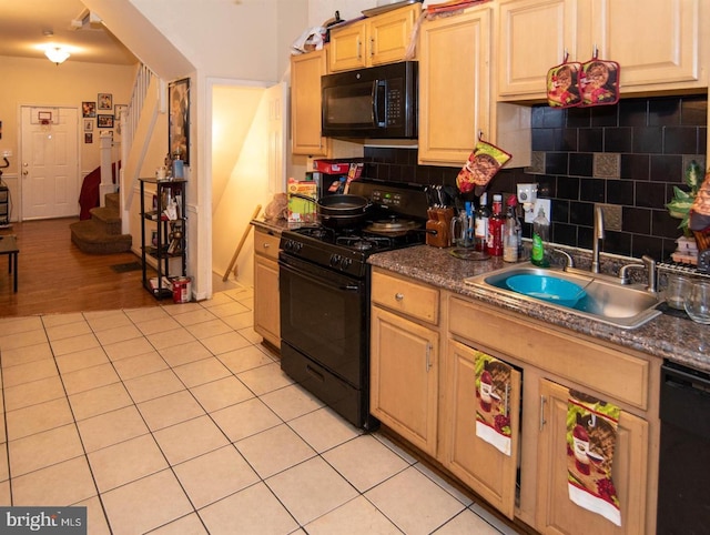 kitchen featuring sink, tasteful backsplash, light hardwood / wood-style flooring, light brown cabinetry, and black appliances