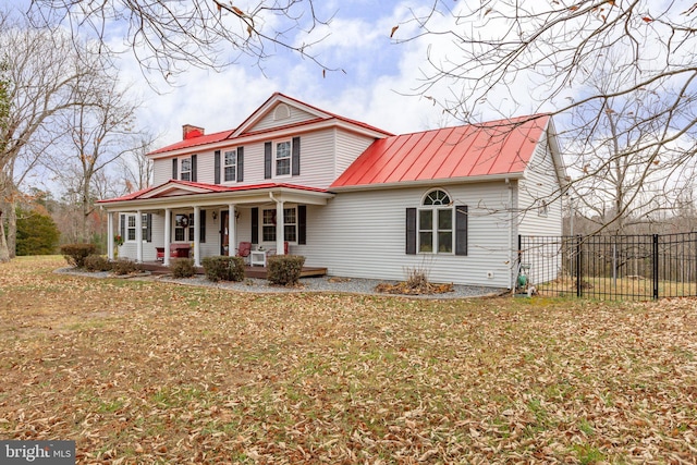 view of front facade with covered porch and a front yard